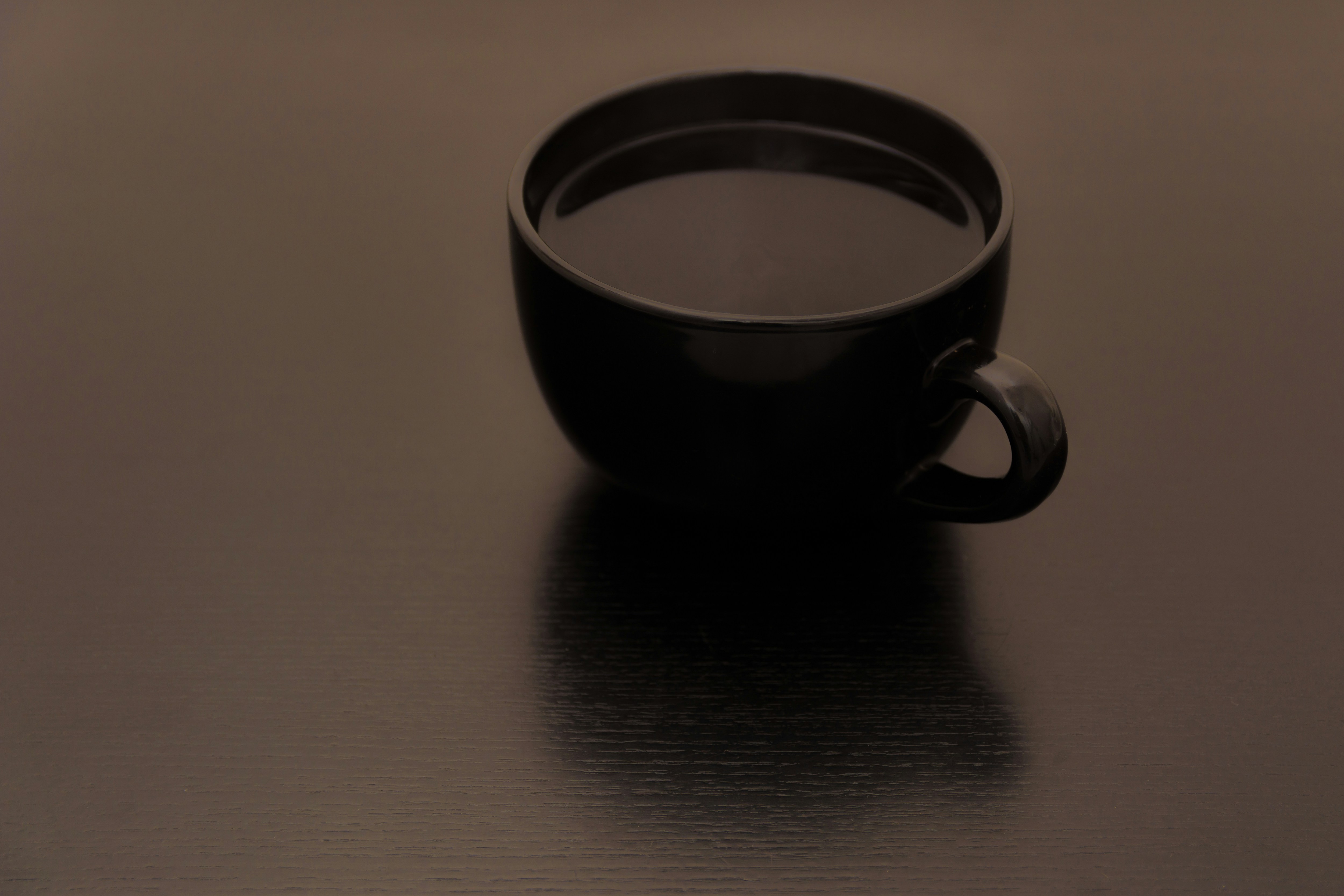 A dark cup of specialty coffee, close focus